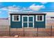Durable storage shed with double doors and windows, providing practical backyard storage at 1385 Morning Sun Way, Las Vegas, NV 89110