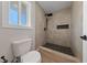 Updated bathroom with a tiled shower, black fixtures, and a window for natural light at 1511 Irene Dr, Boulder City, NV 89005
