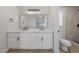 Modern bathroom with double vanity, sleek black hardware, and tiled shower with a glass door at 1511 Irene Dr, Boulder City, NV 89005