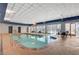 Relaxing indoor pool area with tables, chairs, and a bright view at 211 E Flamingo Rd # 615, Las Vegas, NV 89169
