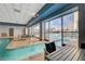 Indoor pool with tables and chairs, large windows, and an outdoor view of the city at 211 E Flamingo Rd # 615, Las Vegas, NV 89169
