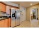 Modern kitchen showcasing stainless steel appliances, wood cabinetry and tile floors at 211 E Flamingo Rd # 615, Las Vegas, NV 89169