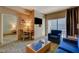 Cozy living room featuring a blue sofa, modern furniture, and a balcony with natural light at 211 E Flamingo Rd # 615, Las Vegas, NV 89169