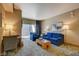 The bright living room has an accent wall, a balcony, a desk, and modern furnishings at 211 E Flamingo Rd # 615, Las Vegas, NV 89169