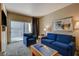 Relaxing living space with a blue sofa, balcony access, and a stylish coffee table at 211 E Flamingo Rd # 615, Las Vegas, NV 89169