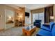 Comfortable living room with a desk, sofa, chair, TV, and balcony access at 211 E Flamingo Rd # 615, Las Vegas, NV 89169