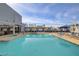 Rooftop pool featuring lounge chairs, umbrellas, and city views with the High Roller visible at 211 E Flamingo Rd # 615, Las Vegas, NV 89169