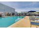 Hotel pool with lounge chairs, umbrellas, and a stunning view of the city skyline at 211 E Flamingo Rd # 615, Las Vegas, NV 89169