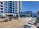 Building blue pool with lounge chairs and tables for an enjoyable outdoor experience at 211 E Flamingo Rd # 615, Las Vegas, NV 89169