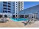 Exterior shot of the building's blue swimming pool with many lounge chairs and a view of the building at 211 E Flamingo Rd # 615, Las Vegas, NV 89169