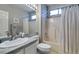 Bright bathroom featuring a tub and shower combination, large mirror, and granite countertops at 2111 Tiger Links Dr, Henderson, NV 89012