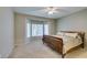Cozy bedroom featuring carpet flooring, bay windows, and a large bed with a wooden frame at 2111 Tiger Links Dr, Henderson, NV 89012