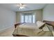 Comfortable bedroom featuring carpet flooring, bay windows, and a large bed with a wooden frame at 2111 Tiger Links Dr, Henderson, NV 89012