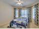 Bright bedroom with a ceiling fan and natural light coming through the windows with nice curtains at 2111 Tiger Links Dr, Henderson, NV 89012
