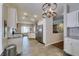 Open-concept kitchen with stainless steel appliances, granite counters, and modern lighting fixtures at 2111 Tiger Links Dr, Henderson, NV 89012