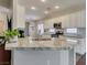 Modern kitchen with white cabinets, granite countertops, and stainless steel appliances at 2111 Tiger Links Dr, Henderson, NV 89012