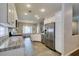 Well-lit kitchen featuring stainless steel appliances, tile flooring, and granite countertops at 2111 Tiger Links Dr, Henderson, NV 89012