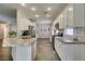 Bright kitchen features granite countertops, white cabinetry, and stainless steel appliances at 2111 Tiger Links Dr, Henderson, NV 89012