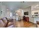 Bright and airy living room flowing into the kitchen, featuring hardwood floors and neutral tones at 2111 Tiger Links Dr, Henderson, NV 89012