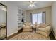 Relaxing sitting room with comfortable chairs, built-in shelving and soft carpet at 2111 Tiger Links Dr, Henderson, NV 89012