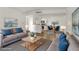 Bright living room with hardwood floors, neutral walls, couches, dining area, and updated kitchen at 2120 Ramrod Ave # 1318, Henderson, NV 89014