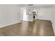 Open-concept living space with hardwood flooring leading into kitchen with white cabinetry at 2120 Ramrod Ave # 1318, Henderson, NV 89014