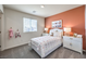 A cheerful bedroom with neutral carpet and bright accents at 240 Mocha Coconut Ave # Lot 103, North Las Vegas, NV 89084