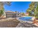 Private backyard featuring a refreshing in-ground pool, covered patio, and ample space for outdoor entertaining at 2504 La Solana Way, Las Vegas, NV 89102