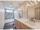 A modern bathroom featuring dual sinks, herringbone tile floors, and a bathtub at 2504 La Solana Way, Las Vegas, NV 89102