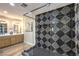 A modern bathroom with a stylish, tiled walk-in shower and elegant fixtures at 2504 La Solana Way, Las Vegas, NV 89102