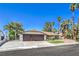 Inviting single-story home featuring a well-maintained front yard, mature trees, and a spacious two-car garage at 2504 La Solana Way, Las Vegas, NV 89102