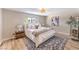 A serene main bedroom with soft lighting, a plush bed, and natural wood floors at 2504 La Solana Way, Las Vegas, NV 89102
