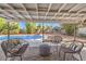 Cozy covered patio featuring stylish outdoor furniture, perfect for enjoying the peaceful backyard setting and pool views at 2504 La Solana Way, Las Vegas, NV 89102