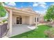 Covered patio offers ample space for outdoor living, with a ceiling fan, and green turf at 2504 Libretto Ave, Henderson, NV 89052