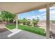 Spacious covered patio overlooks a meticulously landscaped backyard with verdant turf and desert flora at 2504 Libretto Ave, Henderson, NV 89052