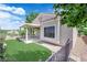The backyard shows a covered patio, artificial turf, and desert landscaping at 2504 Libretto Ave, Henderson, NV 89052