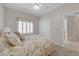 Cozy bedroom with floral bedding, carpet flooring, and window with shutters at 2504 Libretto Ave, Henderson, NV 89052