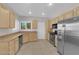 Traditional kitchen featuring wood cabinetry, stainless steel appliances and tile flooring at 2504 Libretto Ave, Henderson, NV 89052