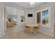 Cozy kitchen area featuring an eat-in table, natural light from the window, and access to the living room at 2504 Libretto Ave, Henderson, NV 89052