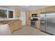 Traditional kitchen featuring wood cabinetry, stainless steel appliances and tile flooring at 2504 Libretto Ave, Henderson, NV 89052
