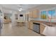 Well-lit kitchen area with ample counter space, wood cabinets, stainless steel dishwasher, and easy access to the living room at 2504 Libretto Ave, Henderson, NV 89052