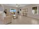 Inviting living room features tile flooring, neutral decor, comfortable sofas, and a sliding door to the patio at 2504 Libretto Ave, Henderson, NV 89052