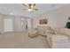 Open-concept living room with tile floors, neutral paint, and comfortable sofas is perfect for entertaining at 2504 Libretto Ave, Henderson, NV 89052