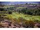 Scenic aerial view of golf course community with rolling hills and lush greenery at 2545 Divine Sky Dr, Henderson, NV 89044
