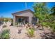 Backyard featuring rocks, plants, shrubs, trees, and a covered patio at 2545 Divine Sky Dr, Henderson, NV 89044