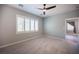 Bedroom featuring plush carpeting, shuttered windows, a modern ceiling fan, and neutral paint at 2545 Divine Sky Dr, Henderson, NV 89044