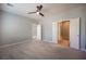 Bright bedroom with multiple doorways, a ceiling fan and neutral carpet at 2545 Divine Sky Dr, Henderson, NV 89044