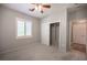 Bedroom featuring neutral walls, ceiling fan, plantation shutters, and closet with sliding doors at 2545 Divine Sky Dr, Henderson, NV 89044