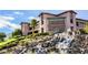 Multi-story building features large windows, a waterfall feature, and professional landscaping at 2545 Divine Sky Dr, Henderson, NV 89044