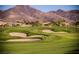 Scenic golf course view with sand traps and lush green grass, set against a backdrop of mountains at 2545 Divine Sky Dr, Henderson, NV 89044